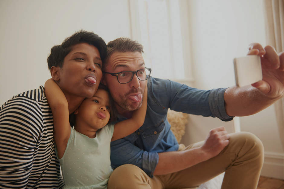Happy family taking selfie together, representing the complexity of unmasking authentically while maintaining family relationships as an autistic ADHD parent