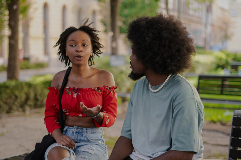 Couple talking on park bench having a serious conversation about relationship communication