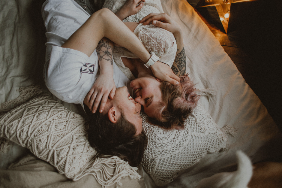 Parents cuddling in bed, connected family moment after resolving RSD communication conflict
