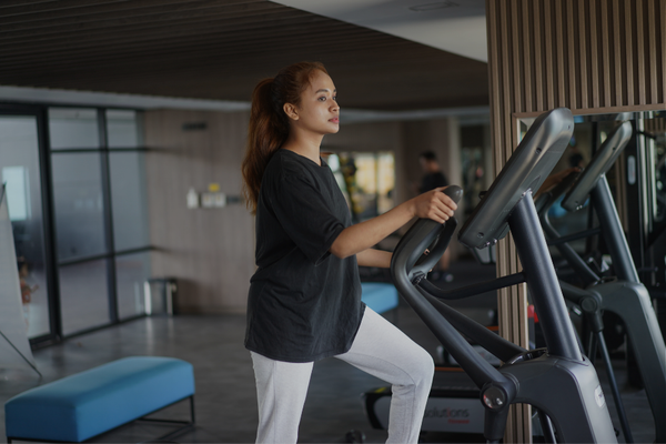 Woman exercising at gym—neurodivergent alternative to rigid fitness goals that don't work for ADHD and autistic brains